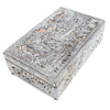 Decorative white metal box with intricate patterns on a white background