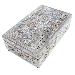 Decorative white metal box with intricate patterns on a white background