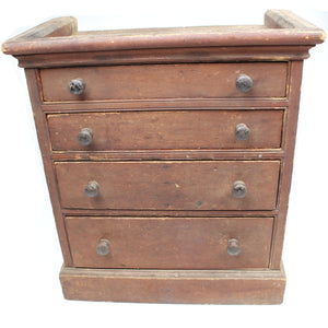 Vintage wooden dresser with four drawers on a white background