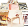 Collection of books on design and furniture, featuring images of chairs and tables.