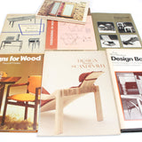 Collection of books on design and furniture, featuring images of chairs and tables.