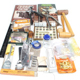 Collection of leatherworking tools and materials on a white background