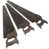 Three vintage hand saws with wooden handles on a white background